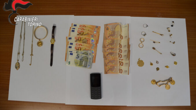 Ha mantenuto il sangue freddo durante tutta la telefonata, ha intuito immediatamente il raggiro e ha collaborato con i carabinieri fino al momento decisivo dell’arresto. Protagonista della vicenda una pensionata di 85 anni residente a Mappano, riuscita a far fallire un tentativo di truffa orchestrato con il classico schema del falso incidente e del presunto intervento sanitario urgente. La donna ha ricevuto una chiamata sul telefono di casa da un uomo che si è presentato come medico dell’ospedale Molinette. Il falso sanitario le ha raccontato che il figlio si trovava in gravi condizioni e che, per affrontare un delicato intervento chirurgico, sarebbe stato necessario reperire immediatamente una somma elevata di denaro. In alternativa, sarebbero bastati gioielli e oggetti preziosi custoditi nell’abitazione. L’anziana, però, ha compreso quasi subito che qualcosa non tornava. Non avendo figli maschi, ha intuito di trovarsi davanti a un tentativo di raggiro e ha contattato la figlia, che a sua volta ha avvisato i carabinieri della Centrale Operativa di Venaria. Il piano concordato con i militari A quel punto è scattata la strategia investigativa. L’operatore della centrale ha consigliato alla pensionata di continuare la conversazione senza interrompere il contatto con i truffatori. La donna ha quindi finto agitazione e smarrimento, lasciando credere di essere caduta nella trappola. Durante la chiamata, il sedicente medico ha passato il telefono a un complice che impersonava il figlio malato. Con voce sofferente, l’uomo ha spiegato che una donna sarebbe passata di lì a poco a ritirare l’oro necessario per coprire parte delle spese mediche. Nel frattempo i carabinieri della Sezione Operativa di Venaria e della Stazione di Leinì avevano già raggiunto l’abitazione dell’anziana, predisponendo un servizio discreto all’interno della casa. L’arresto in flagranza Pochi minuti dopo si è presentata una donna di 41 anni, cittadina polacca, che ha ritirato i monili preparati dall’anziana. Appena entrata in possesso degli oggetti preziosi, i militari sono intervenuti bloccandola e arrestandola in flagranza con l’accusa di tentata truffa aggravata. Nel corso della perquisizione personale, i carabinieri hanno trovato anche altri gioielli, un orologio del valore stimato di circa 15 mila euro e 350 euro in contanti. Gli investigatori sospettano che il materiale possa provenire da analoghi episodi avvenuti recentemente nel Torinese. Per questo motivo sono in corso ulteriori accertamenti. Un precedente già nel 2024 Per l’85enne non si tratta del primo episodio simile. Già nel febbraio del 2024 era riuscita a sventare un’altra truffa con modalità analoghe, consentendo in quell’occasione l’arresto di un giovane cittadino tedesco di 18 anni. Grazie alla prontezza dimostrata anche questa volta, la pensionata è riuscita a rientrare in possesso dei propri gioielli senza subire danni economici. La quarantunenne arrestata è stata invece trasferita nel carcere “Lorusso e Cutugno” di Torino, dove resta a disposizione della Procura di Ivrea che coordina le indagini.